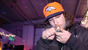 Man Smoking Marijuana from Pipe in Denver Cannabis Club